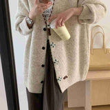 Knitted cardigan with contrast color single-row buttons.