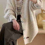 Knitted cardigan with contrast color single-row buttons.