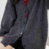 Knitted cardigan with contrast color single-row buttons.