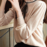 Knitted top with ruffled lace tie decoration