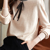 Knitted top with ruffled lace tie decoration