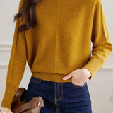 Round-neck sweater with cuffed hem.