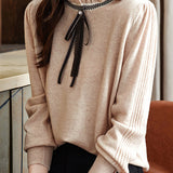 Knitted top with ruffled lace tie decoration